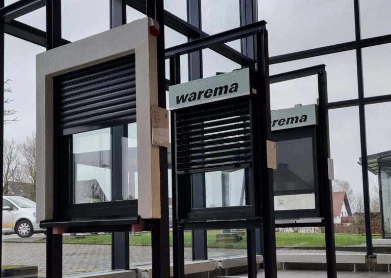 Fenster mit Rollläden in einem modernen Gebäude, Sicht auf den Außenbereich.